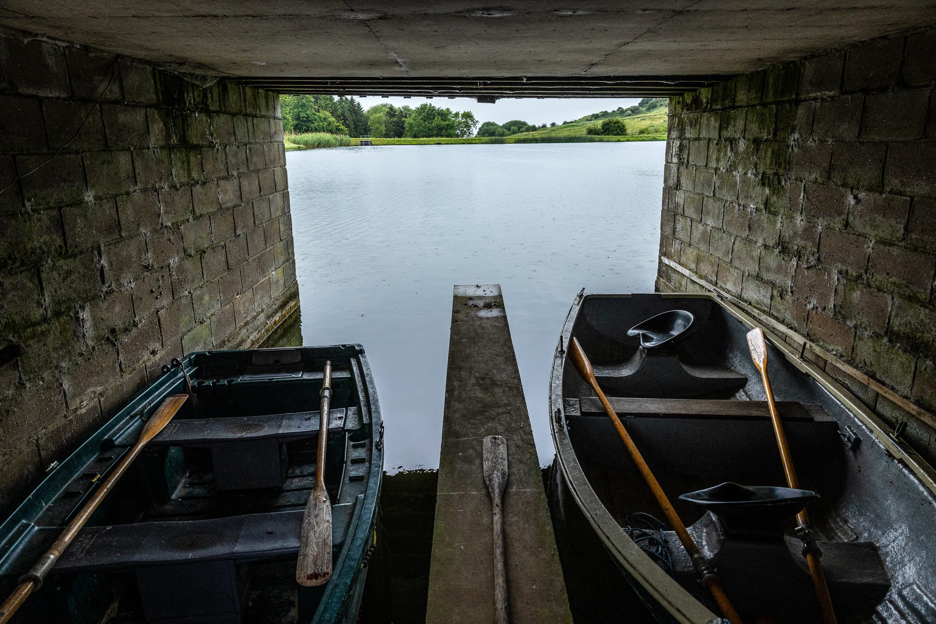 Boats docked under the Boat House, ready for launch into the lake.