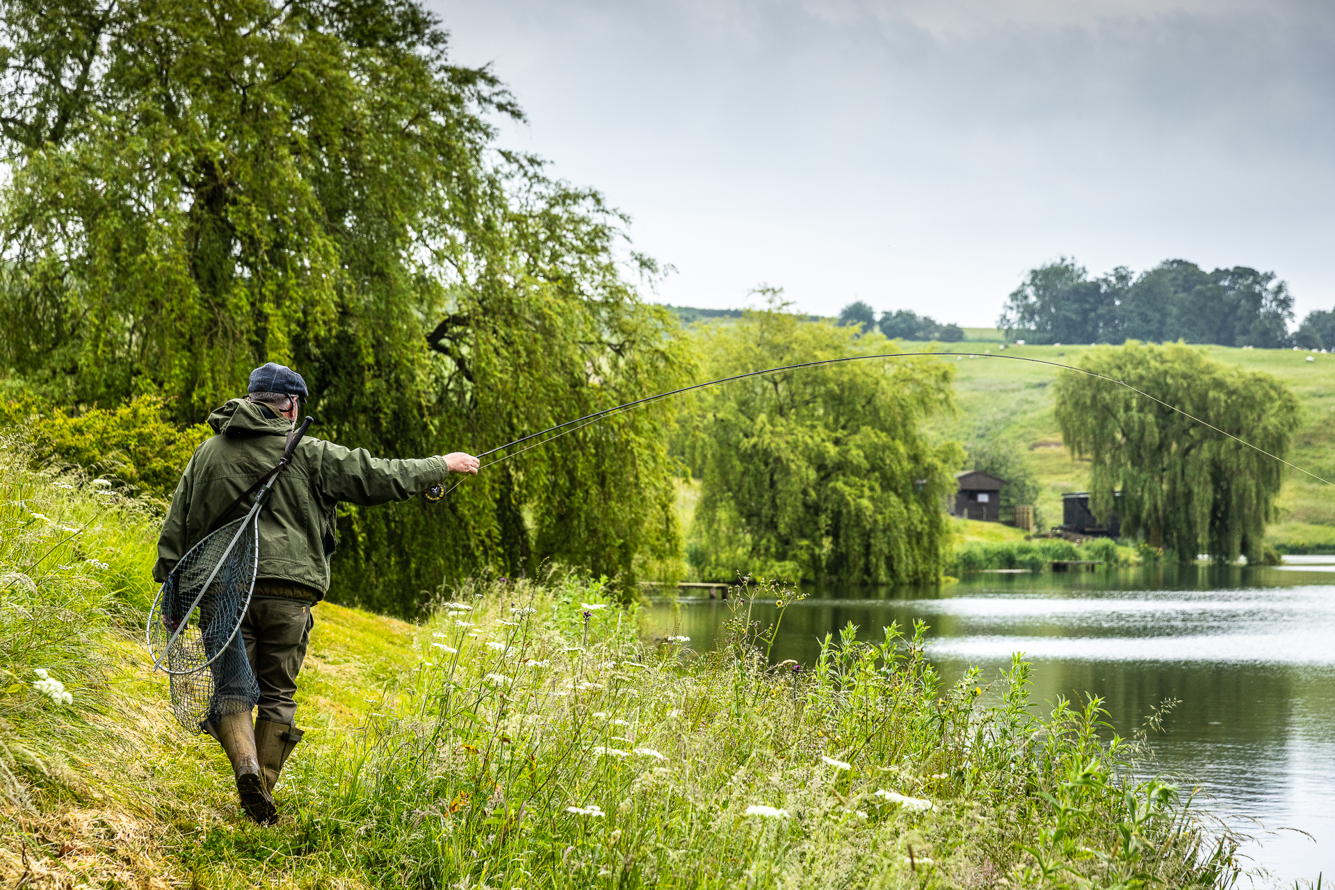 Fisherman traversing the lake with their fishing rod