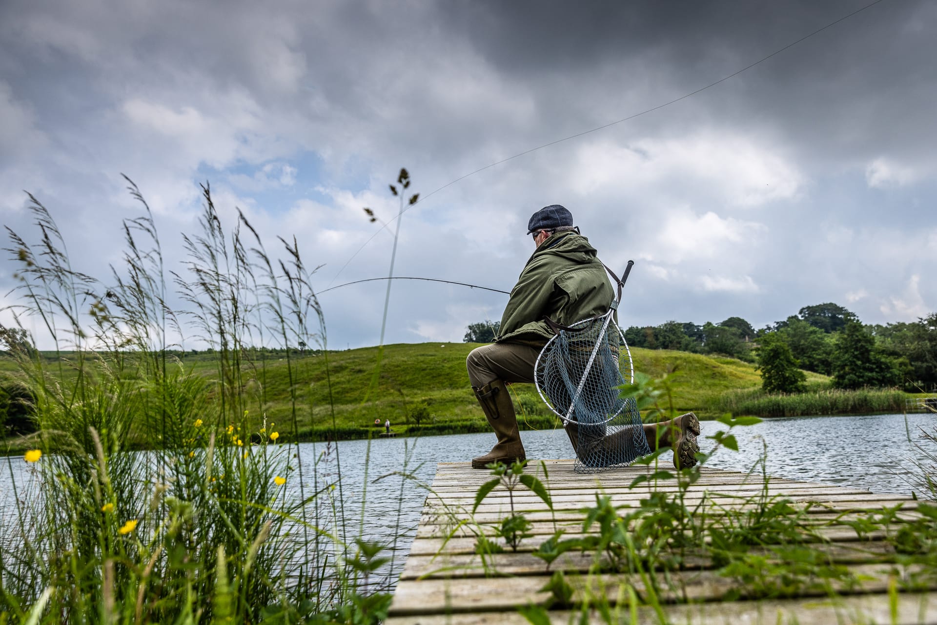 Fisherman casting line from fishing dock