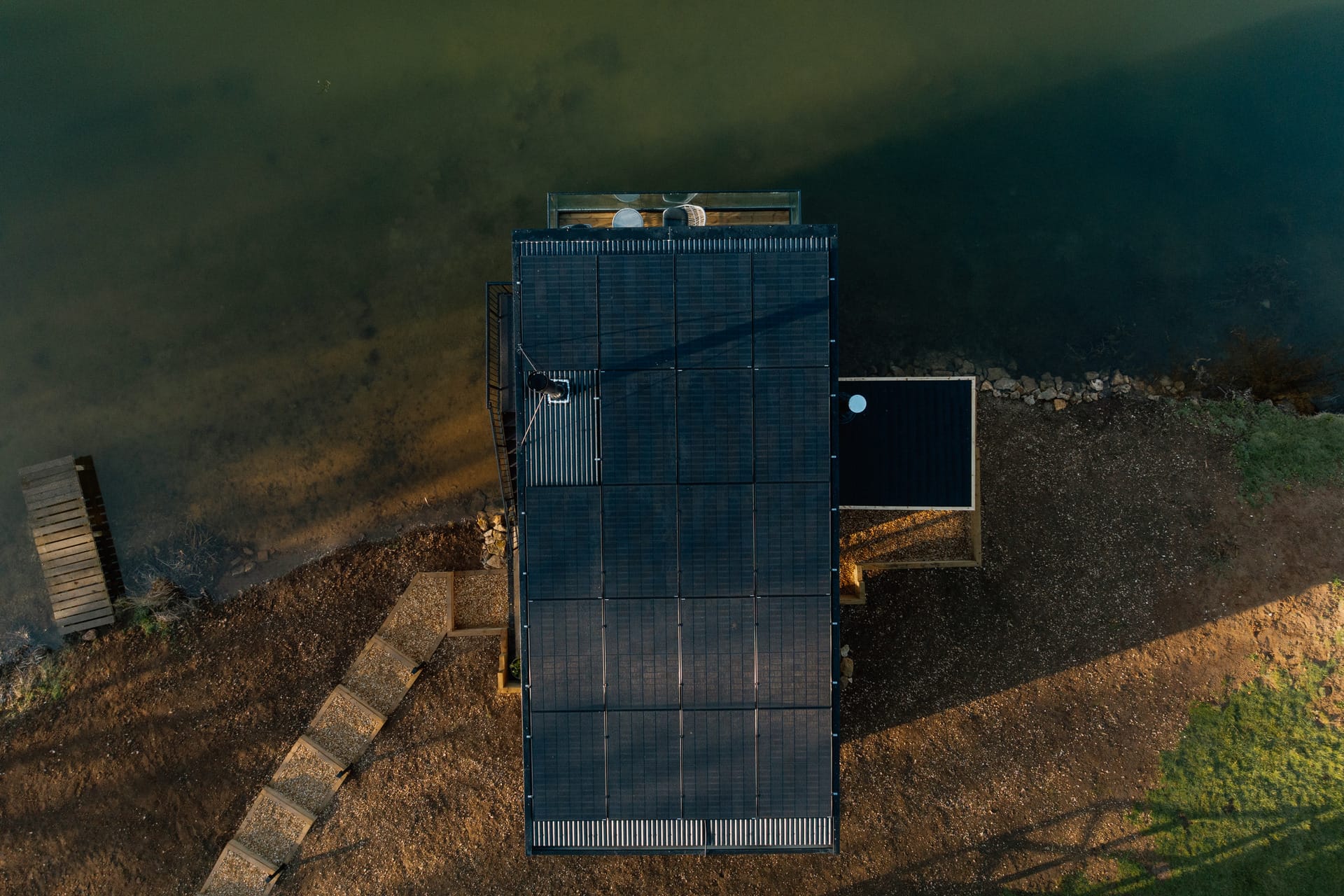 Top down view of the Otby Boat House showing solar panels and the steps down to the door