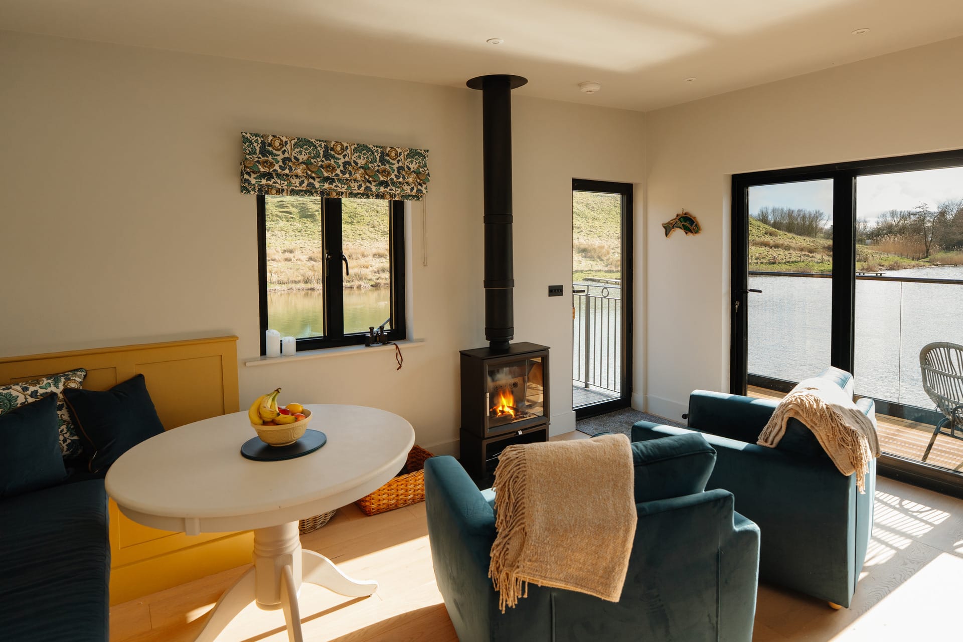 The Otby Lake House cozy with log fire and sliding doors to a balcony