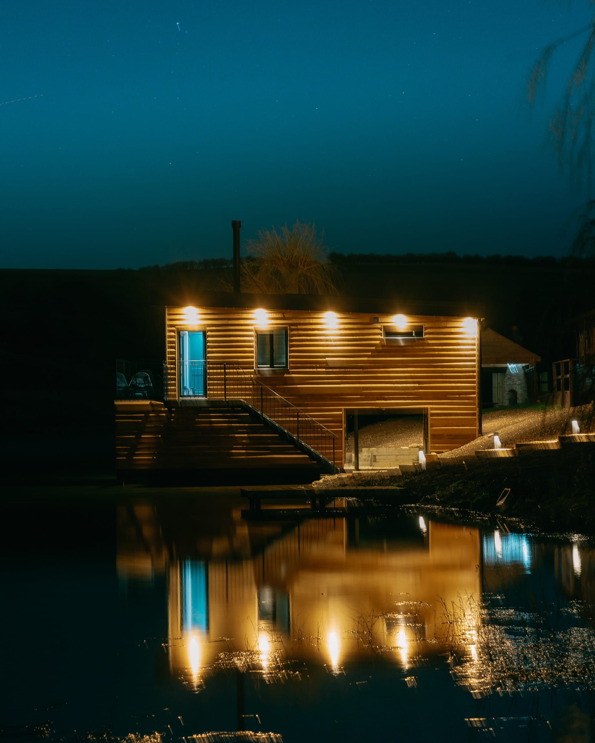 Otby Boat House in the evening with all lights on