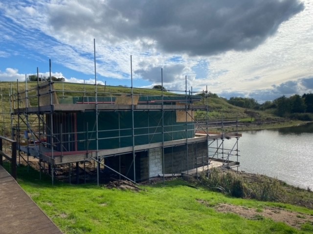 Otby house during the building process with scaffolding on all four sides
