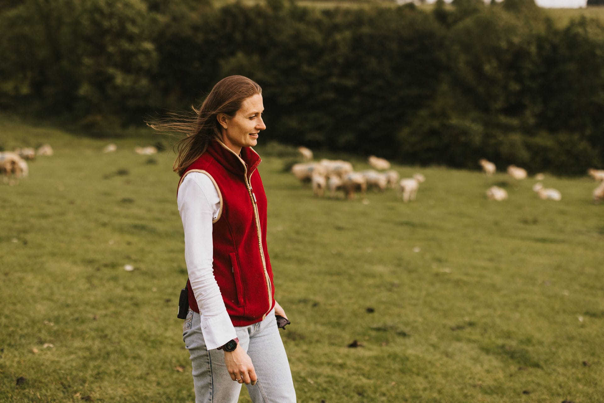 Natalie standing in a sheep field
