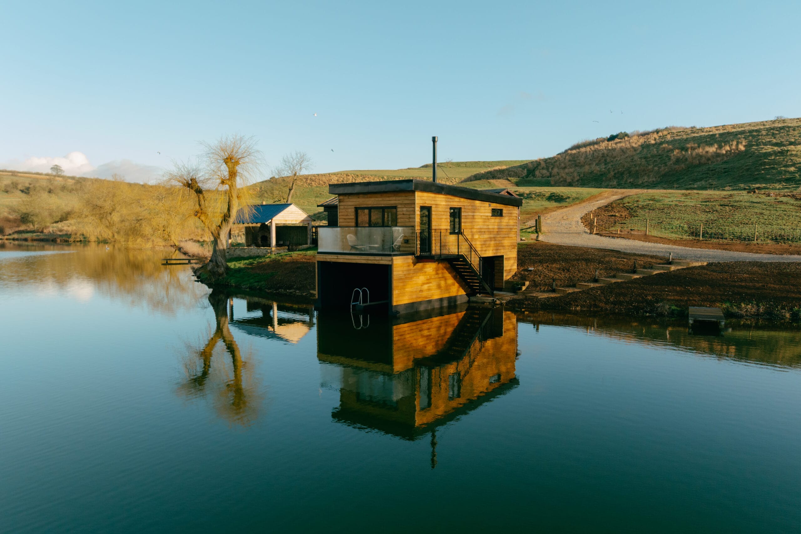 Otby Lake Boat House reflected in the still lake water on a spring morning
