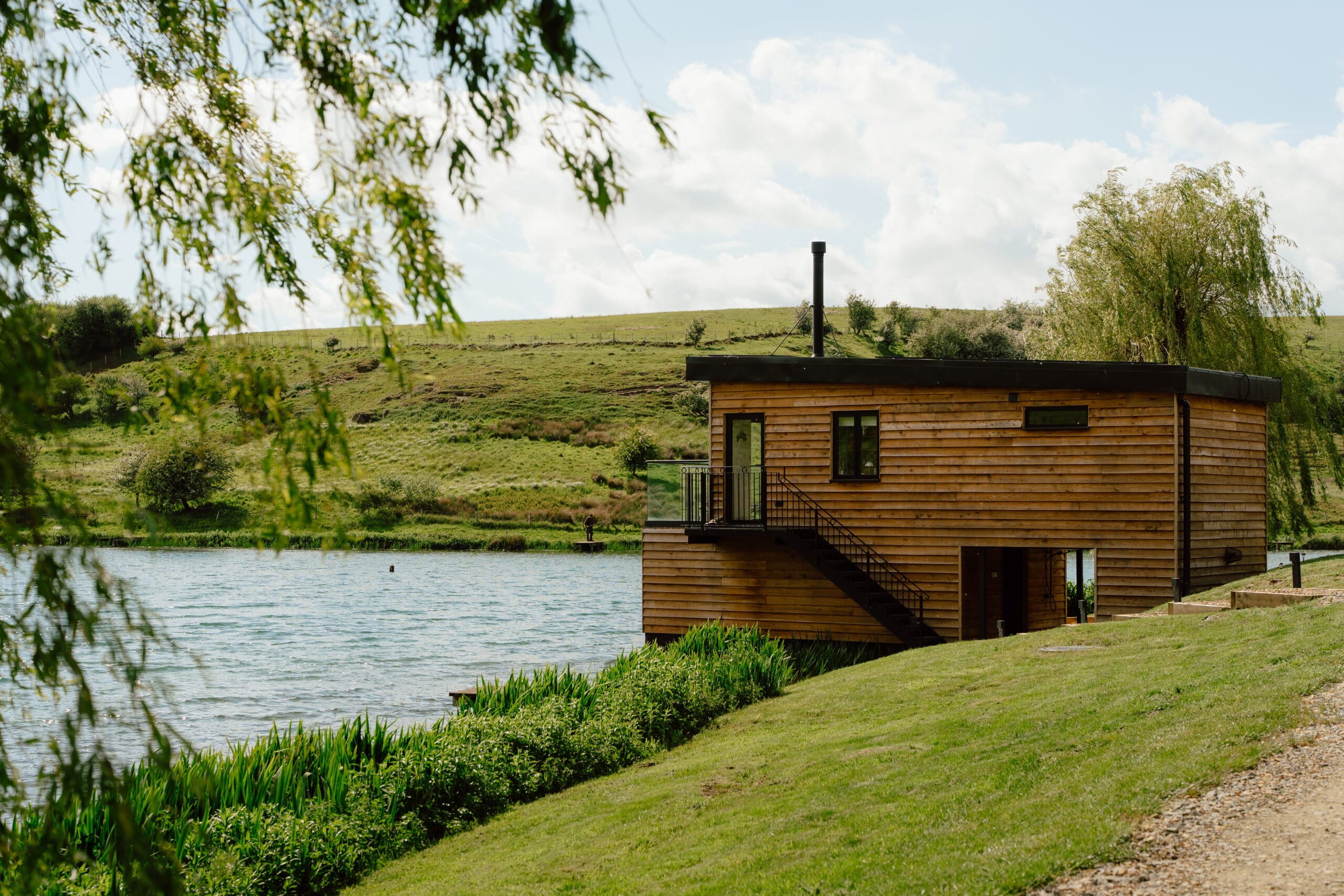 Spring at Otby Lake Boat House. Showing the side profile of the Boat House with the steps up to the first floor.